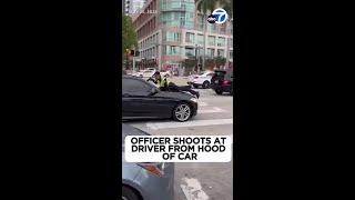 Cop shoots driver through windshield while clinging to hood of car