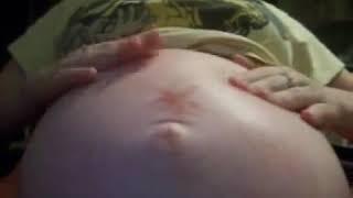 Jen playing with her belly (from 1st alien pregnancy)