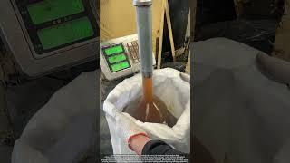 Worker Filling 40kg Grease into Woven Bag via Metal Nozzle