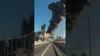 Smoke billows into the sky from burning building #aivideo #war #explosion