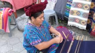 Maya woman in Guatemala creates a hand made blanket and clothing one thread at a time.