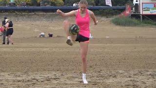 Pretty Blonde Girl in pink showing off her Soccer skills on the Beach