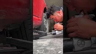 The process of lifting the vehicle with a jack screw and opening the wheel nuts