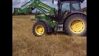 Collecting hay bales.