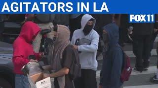 Group hands out riot gear masks during LA anti-ICE protests | FOX 11 LA