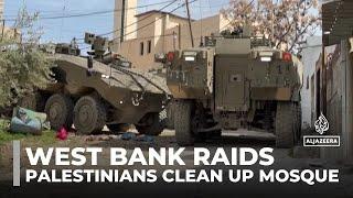 Palestinians clean up mosque after Israeli troops set it on fire during West Bank raids