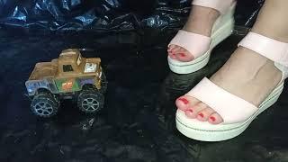 Goddess Lady L crush brown toy car jeep with pink platform high heels.