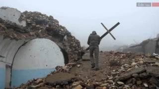 Ezidi fighters raising cross on a destroyed Assyrian church in Shingal