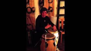 Liam MacDonald recording congas in the studio