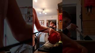 The son helps to prepare food. Cooking