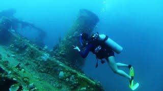 Woman Scuba Diver Explores Sunken Wreck