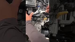 The process of opening the engine cover using wrenches
