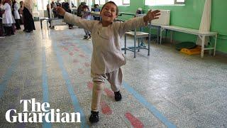 Beaming young Afghan amputee dances on new prosthetic leg