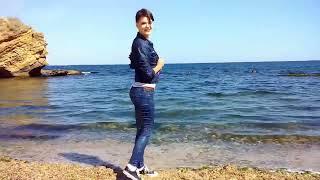 beautiful girl in wet denim clothes resting on the sea