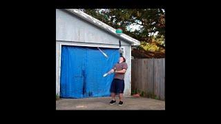 Man Juggles Clubs While Balancing A Leaf Blower With Beach Ball Floating On Top