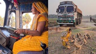 This Indian woman's heavy loaded truck driving on a new constructing road & her langoors service.