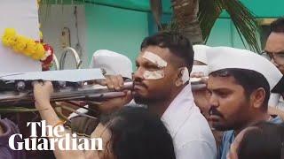 Sole India plane crash survivor mourns his brother during funeral