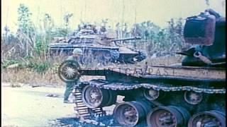 US 1st Infantry Division soldiers check a destroyed M-48 Patton tank on a road in...HD Stock Footage