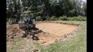 leveling a pad for a garage with a bobcat excavator