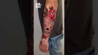 Traditional Mexican sugar skull tattoo with red roses