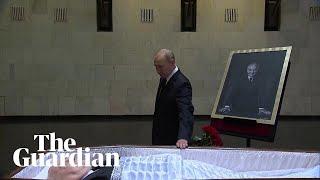 Vladimir Putin lays flowers next to open coffin of Mikhail Gorbachev