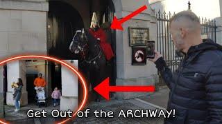 The horse is unsettled by the tourist while police officer told the family to get out of the archway