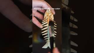 Carving an oak wood fish comb