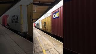 Rail Freight Train  zooming past Platform 1 in Tamworth Railway Station  UK