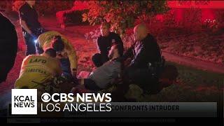 A Van Nuys homeowner detains an intruder after he breaks through glass doors at the home