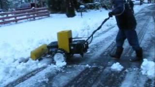 Walk behind electric snow plow.