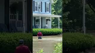 Man wades through thigh-high water in flood-hit areas of Vermont