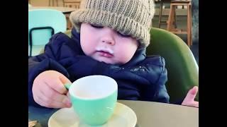 Toddler drinking a babychino.