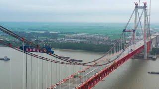 GLOBALink | China's 1st double-deck cable-stayed suspension bridge completes closure