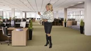 Crossdresser modeling various satin blouses, leather skirt knee high boots in the office