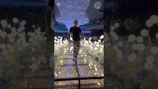 The supermodel godfather, strolling under the flowers and the moon.