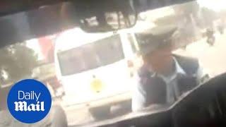 Traffic policeman gets dragged on car bonnet by irate driver in India