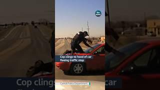 An #iowa #police officer held onto the hood of a car while trying to stop a fleeing man #itvnews