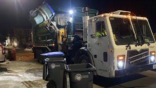 WM garbage truck with a busted grill packing recycling