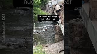 Daredevil Dad Tempts Huge Black Bear That Appears By Downtown Riverbank