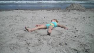 Grace making sand angels.....