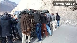 tourist vehicle got accident at sost pak china border khunjerab pass, people are helping to move it.