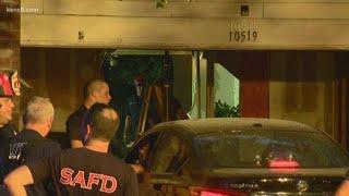 Car plows through garage door pushing another car through home