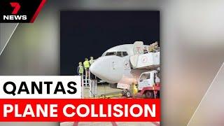 Qantas plane collides with aero bridge at Brisbane Airport | 7NEWS