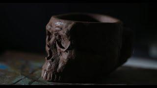 Hand building a skull coffee mug with water clay