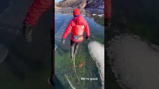 Woman ice skates on frozen lake as the ice starts to crack