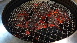 BBQ cooking station being prepared at Roddeeded restaurant in Bangkok, Thailand