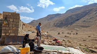 Iran nomadic life: washing blankets and clothes to prepare the bedroom