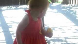 Evaning enjoying her Great Auntie Annie's Peaches in her peach orchard in California 