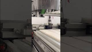 3 Axis CNC Router with automatic tool change cutting carbon fibre with dust extraction.