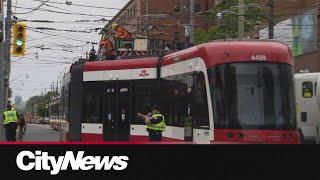 TTC streetcar derails off busy intersection blocking commuters